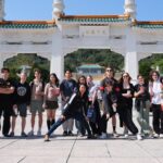 Brentwood students standing in front of the gate to the National palace Museum in Taipei, Taiwan on a sunny day.