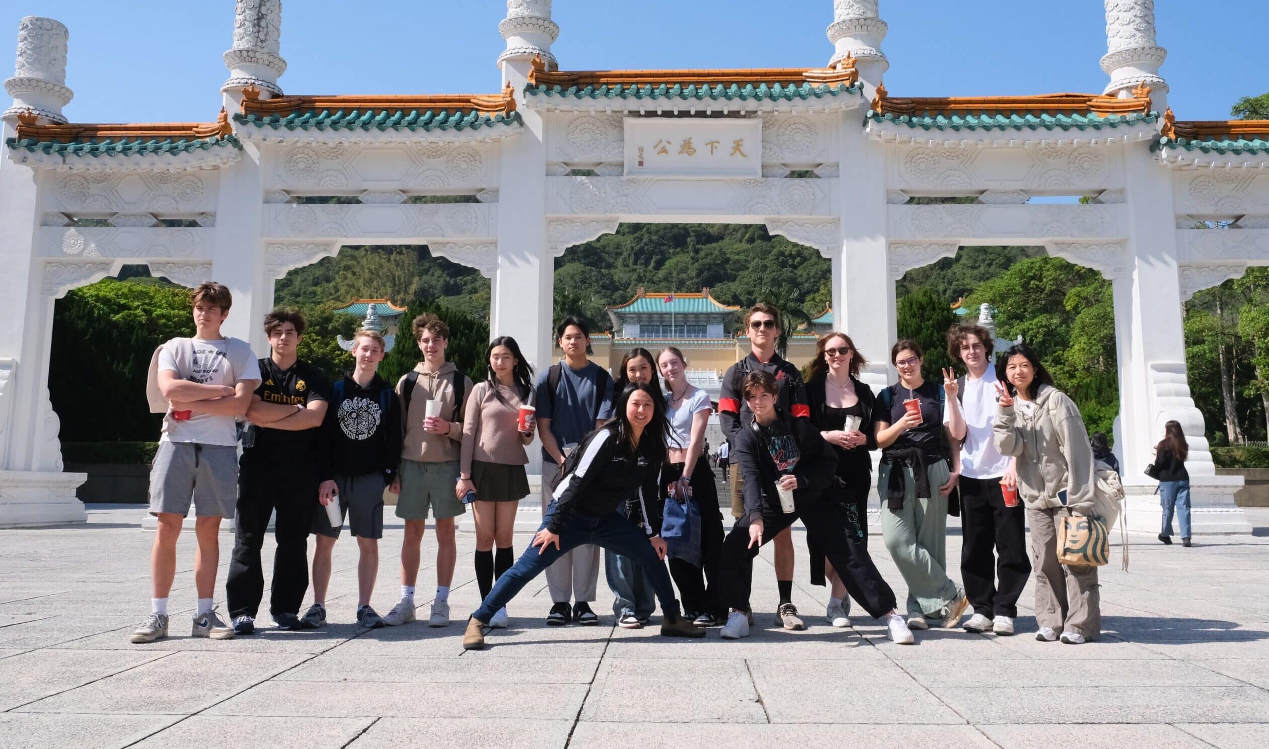 Brentwood students standing in front of the gate to the National palace Museum in Taipei, Taiwan on a sunny day.