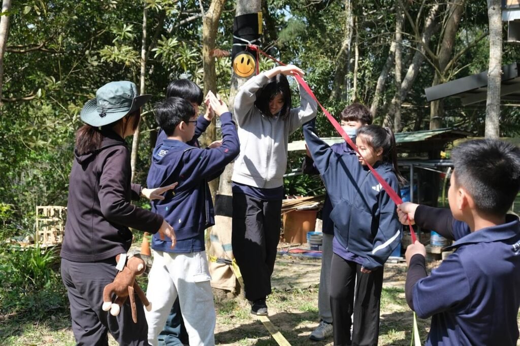 Students participating in outdoor education trip in Miaoli Taiwan - slacklining experience